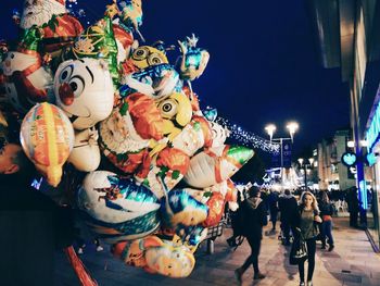 Low angle view of illuminated carousel in city