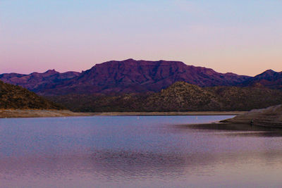 Scenic view of lake and mountains against clear sky