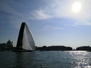 Sailboat sailing on sea against sky