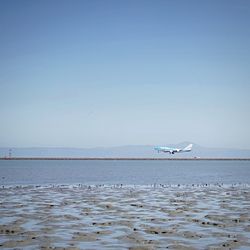 Boats in sea against clear sky