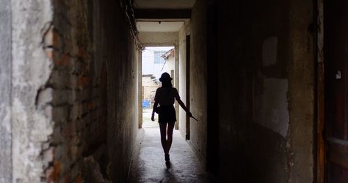 Rear view of man walking in corridor