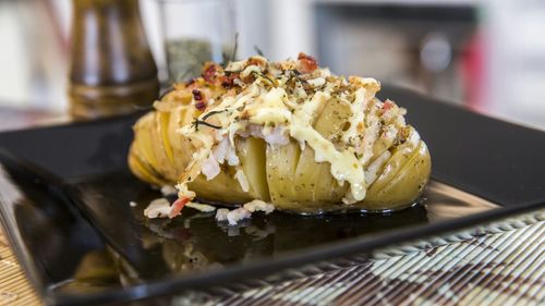 High angle view of hasselback potato in plate on table