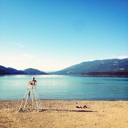 Rear view of a lifeguard watching the beach