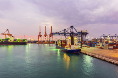 Container ships at illuminated dock