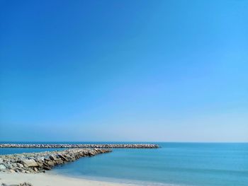 Scenic view of sea against clear blue sky