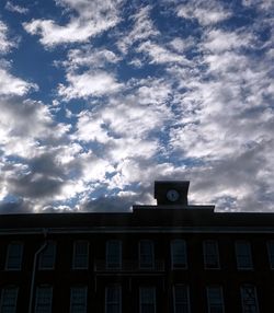 Low angle view of building against cloudy sky