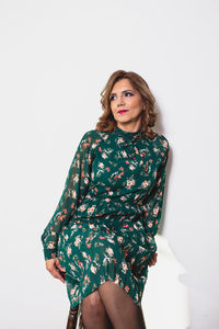 Portrait of woman standing against white background