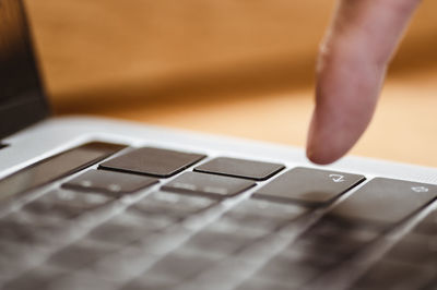 Cropped image of hand using computer keyboard