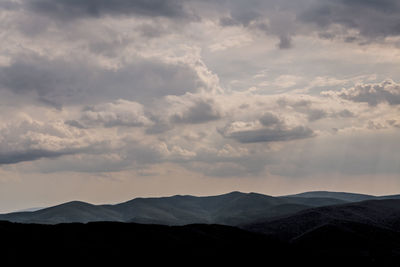 Scenic view of silhouette mountains against sky during sunset