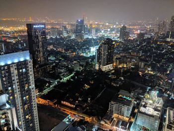 High angle view of illuminated buildings in city at night