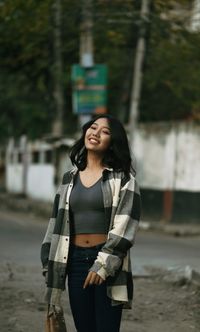 Portrait of young woman standing outdoors