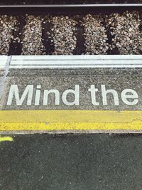 High angle view of text on railroad station platform