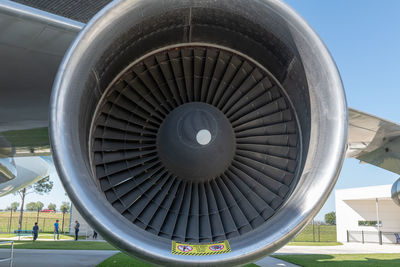 Close-up of airplane at airport runway against sky