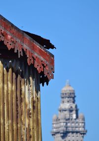 Low angle view of old building against clear blue sky