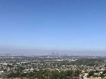 High angle view of buildings against blue sky