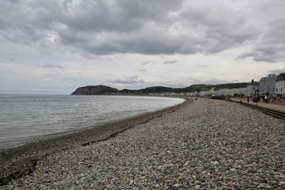 Scenic view of beach against sky in city