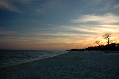 Scenic view of beach against sky during sunset