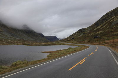 Empty road by mountains