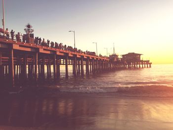 Pier on sea at sunset