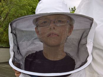 Portrait of beekeeper wearing protective workwear