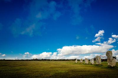 Scenic view of field against blue sky