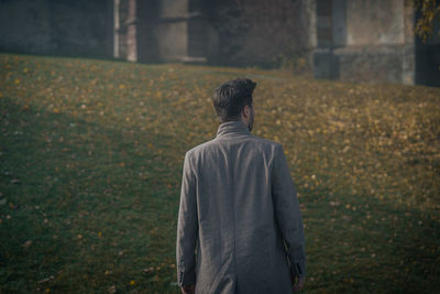 Rear view of man walking towards a castle