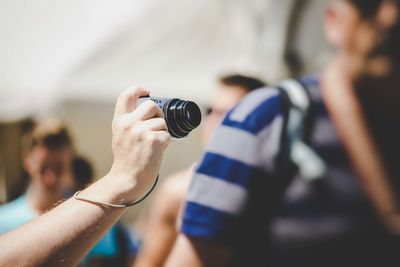 Midsection of woman photographing camera