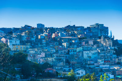 High angle view of townscape against blue sky