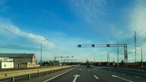 Road sign against blue sky