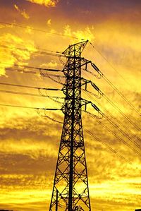 Low angle view of electricity pylon against sky
