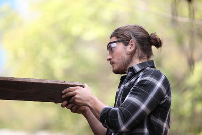 Side view of young man looking away