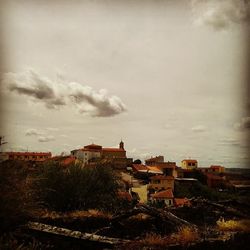 Houses against cloudy sky
