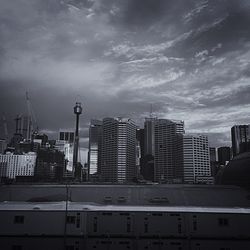 Buildings against cloudy sky