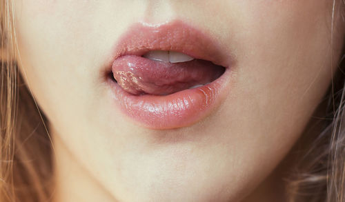 Close-up of woman licking lips