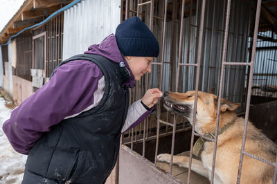 Girl volunteer in the nursery for dogs. shelter for stray dogs.