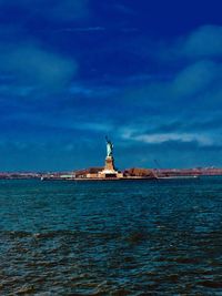 Statue of sea against cloudy sky