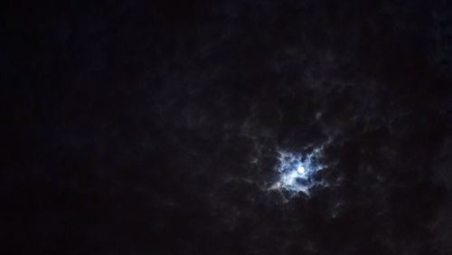 Low angle view of moon in sky at night