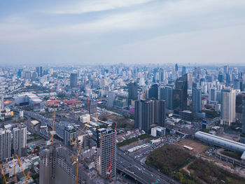 High angle view of modern buildings in city against sky