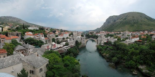 Town by mountains against sky