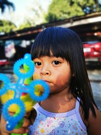 Portrait of girl holding toy