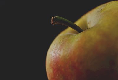 Close-up of apple against black background