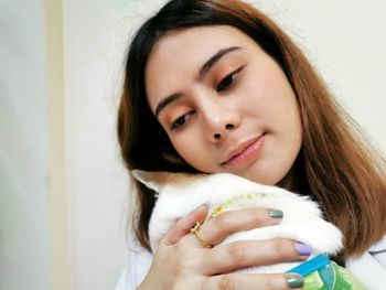 Close-up portrait of a beautiful young woman at home