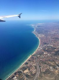 Cropped image of airplane flying over sea