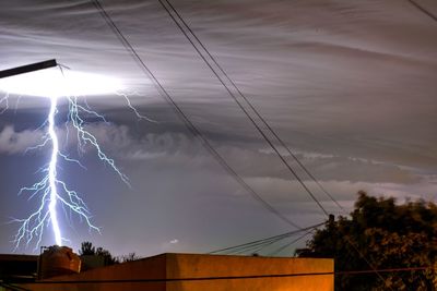 Low angle view of lightning against sky during sunset