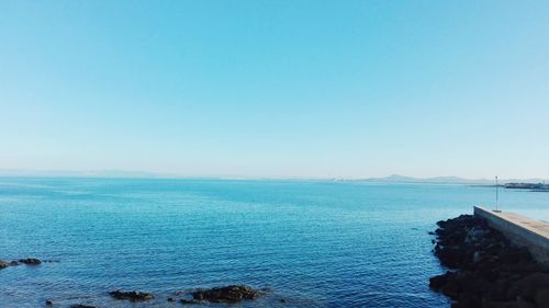 Scenic view of sea against clear blue sky