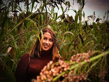 Portrait of a smiling young woman on field