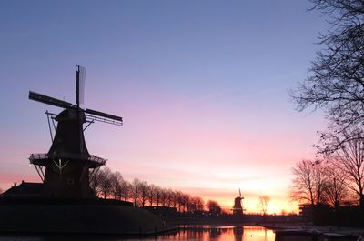 Low angle view of buildings against clear sky during sunset