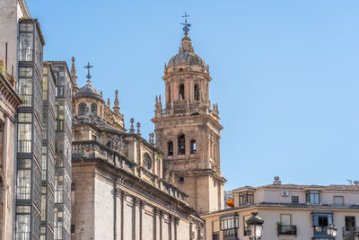 Low angle view of historic building against clear blue sky