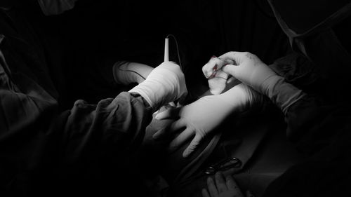 Doctors operating patient in hospital