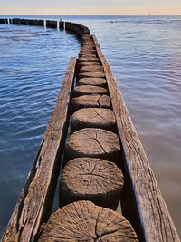 Wooden pier over sea against sky